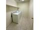 Functional laundry room with tile floors, shelving, and a washer and dryer at 7607 Pioneer Ranch Ave, Las Vegas, NV 89113