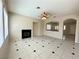 Open-concept living room with tile floor, fireplace, and generous natural light at 7607 Pioneer Ranch Ave, Las Vegas, NV 89113