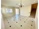 Comfortable living space featuring tile floors, staircase and bright windows at 7607 Pioneer Ranch Ave, Las Vegas, NV 89113