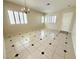 Open-concept living room featuring tile flooring, neutral paint, and large windows at 7607 Pioneer Ranch Ave, Las Vegas, NV 89113