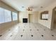 Spacious living area with tile flooring, fireplace, and arched entryways at 7607 Pioneer Ranch Ave, Las Vegas, NV 89113