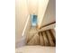 Carpeted stairs descending to the lower level with a wooden railing and neutral walls at 7607 Pioneer Ranch Ave, Las Vegas, NV 89113
