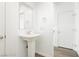 Bathroom with a pedestal sink, wood-look floors, and white walls and doors at 7777 Vino Vranec Ct, Las Vegas, NV 89113