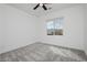 Bright bedroom featuring a ceiling fan and a window with scenic views at 7777 Vino Vranec Ct, Las Vegas, NV 89113