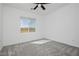 This bedroom features a ceiling fan and a window with scenic views at 7777 Vino Vranec Ct, Las Vegas, NV 89113
