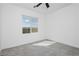 Bright bedroom featuring a ceiling fan and a window with scenic views at 7777 Vino Vranec Ct, Las Vegas, NV 89113