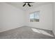 Bright bedroom featuring a ceiling fan, neutral walls, and plush gray carpeting at 7777 Vino Vranec Ct, Las Vegas, NV 89113