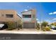 Two-story home features modern architecture, neutral tones, a two-car garage, and low-maintenance landscaping at 7777 Vino Vranec Ct, Las Vegas, NV 89113