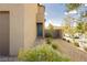 Exterior of a home showing a pathway to the front door with desert landscaping including rocks and small plants at 7777 Vino Vranec Ct, Las Vegas, NV 89113