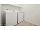 This light-filled laundry room has a washer and dryer, plus tiled floors at 7777 Vino Vranec Ct, Las Vegas, NV 89113