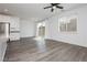 Living room features gray wood floors and sliding glass doors leading to the backyard at 7777 Vino Vranec Ct, Las Vegas, NV 89113