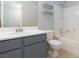 Bathroom with gray vanity, white countertop sink, toilet, and tiled shower-tub combination at 7885 W Flamingo Rd # 2005, Las Vegas, NV 89147