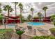 Community pool featuring lounge chairs, cabanas, palm trees, and well-maintained landscaping at 7885 W Flamingo Rd # 2005, Las Vegas, NV 89147