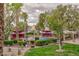 Exterior view of a pool area with surrounding landscaping, mature trees, and lounge seating at 7885 W Flamingo Rd # 2005, Las Vegas, NV 89147