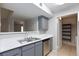 Well-lit kitchen featuring gray cabinets, stainless steel appliances, and a double basin sink at 7885 W Flamingo Rd # 2005, Las Vegas, NV 89147