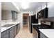 Modern kitchen featuring stainless steel appliances, gray cabinets, and tiled flooring at 7885 W Flamingo Rd # 2005, Las Vegas, NV 89147