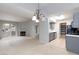 Open living room with neutral carpet, fireplace, chandelier, and sliding glass door to the patio at 7885 W Flamingo Rd # 2005, Las Vegas, NV 89147