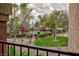 View of the community pool featuring a lush green landscape, mature trees and shaded seating areas at 7885 W Flamingo Rd # 2005, Las Vegas, NV 89147
