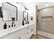 This bathroom features double sinks, a stone shower, modern fixtures and ample light at 811 Spyglass Ln, Las Vegas, NV 89107