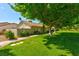 Beautiful single-story home with a well-maintained lawn and mature shade trees at 811 Spyglass Ln, Las Vegas, NV 89107