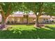 Inviting home featuring a manicured green lawn and mature trees at 811 Spyglass Ln, Las Vegas, NV 89107