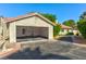 Spacious garage with open door, interior shelving, and an asphalt driveway at 811 Spyglass Ln, Las Vegas, NV 89107