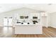 Bright kitchen showcasing white cabinetry, marble countertops, an island, and stainless steel appliances, exuding modern elegance at 811 Spyglass Ln, Las Vegas, NV 89107