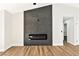 Modern fireplace with dark stone tile surround complements the light wood flooring in this open living space at 811 Spyglass Ln, Las Vegas, NV 89107
