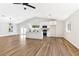 Bright open-concept living space with vaulted ceilings and modern kitchen featuring an island and stainless steel appliances at 811 Spyglass Ln, Las Vegas, NV 89107