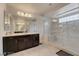 Bathroom featuring a large vanity with granite countertop and a glass-enclosed shower with bench at 8176 Duncan Peak Ct, Las Vegas, NV 89139