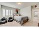 Comfortable bedroom featuring a cozy bed, two beanbag chairs, and a window with shutters at 8176 Duncan Peak Ct, Las Vegas, NV 89139