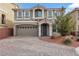 Charming home featuring manicured landscaping, a paved driveway, and a two-car garage at 8176 Duncan Peak Ct, Las Vegas, NV 89139