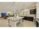 Modern kitchen with dark cabinets, stainless appliances, and large kitchen island with a view into the Gathering room at 8176 Duncan Peak Ct, Las Vegas, NV 89139