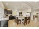 Well-lit kitchen with stainless steel appliances, granite countertops, and a large kitchen island with bar stool seating at 8176 Duncan Peak Ct, Las Vegas, NV 89139
