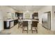 Spacious kitchen features dark cabinets, granite countertops, a large island with bar seating, and stainless appliances at 8176 Duncan Peak Ct, Las Vegas, NV 89139