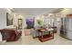 Open-concept living room featuring tile flooring, a large television, and stainless steel refrigerator at 8176 Duncan Peak Ct, Las Vegas, NV 89139