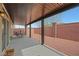 Covered patio with an outdoor dining area and a view of the fenced yard, perfect for entertaining at 8176 Duncan Peak Ct, Las Vegas, NV 89139