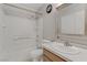This bathroom includes a vanity with a white countertop and a shower-tub combo with tiled walls at 8450 Alta Dr # 220, Las Vegas, NV 89145