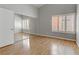 This bedroom has mirrored closet doors, natural light, and wood floors at 8450 Alta Dr # 220, Las Vegas, NV 89145