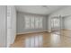 Bright bedroom features a ceiling fan, wood floors, and lots of natural light from the large windows at 8450 Alta Dr # 220, Las Vegas, NV 89145