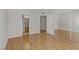 This bedroom offers wood floors, neutral walls, and a view of the bathroom and closet space at 8450 Alta Dr # 220, Las Vegas, NV 89145