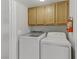 A convenient laundry room offers overhead cabinets and modern washer and dryer appliances at 8450 Alta Dr # 220, Las Vegas, NV 89145