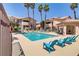 Community pool area with sun loungers, seating areas, and lush landscaping for relaxation and enjoyment at 8450 Alta Dr # 220, Las Vegas, NV 89145