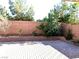 Well-maintained backyard with a brick retaining wall, landscaping, and ample space for outdoor activities at 8977 Melridge Rd, Las Vegas, NV 89148