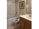 Bright bathroom featuring a shower-tub combo, wooden vanity, and framed wall art at 8977 Melridge Rd, Las Vegas, NV 89148