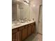 Bathroom with double sink vanity and wood cabinets, providing ample storage at 8977 Melridge Rd, Las Vegas, NV 89148