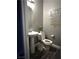 Stylish powder room features a pedestal sink, unique wall art, and modern fixtures at 8977 Melridge Rd, Las Vegas, NV 89148