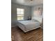 Bedroom features a hardwood floor, with a large window at 8977 Melridge Rd, Las Vegas, NV 89148