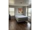 Simple bedroom features a bright window, and hardwood floors at 8977 Melridge Rd, Las Vegas, NV 89148