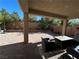 Covered patio area with outdoor seating, creating a comfortable space for relaxation and entertaining at 8977 Melridge Rd, Las Vegas, NV 89148